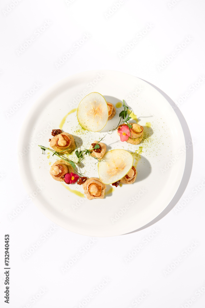 Top View of Seared Sea Scallops with Apple and Celery Puree on White Top View of Seared Sea Scallops with Apple and Celery Puree on White