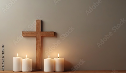 christian cross with candles on wooden floor in room, copy space photo