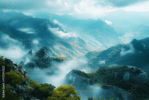 Majestic Mountains Shrouded in Mist, A breathtaking landscape of towering mountains veiled by soft mist, showcasing nature's grandeur in a serene valley. © Nongkran