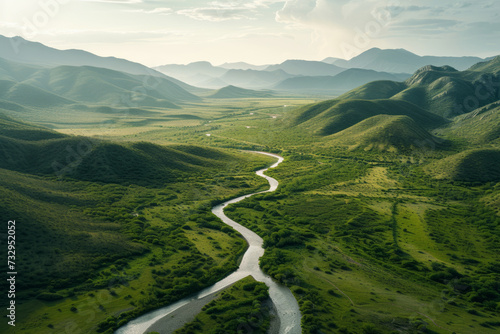 Meandering River Through Lush Green Valleys, An aerial view captures a meandering river cutting through vibrant green valleys, with rolling hills fading into the misty horizon.