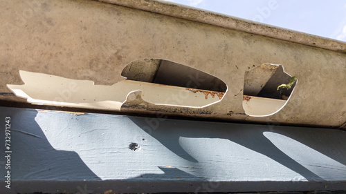 Damaged Gutters after a hail storm with holes and impact of large hailstones waiting gutter Repair Roof Guttering photo