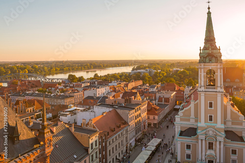Aerial panoramic view of historical buildings and roofs in Polish medieval town Torun at sunset