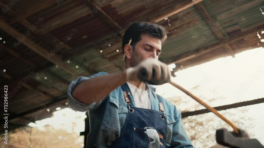 Craftsman skillfully measures a piece of wood with a tape measure, Carpenter is doing a business making wooden furniture in a wood shop Craftsman skillfully measures a piece of wood with a tape measure, Carpenter is doing a business making wooden furniture in a wood shop