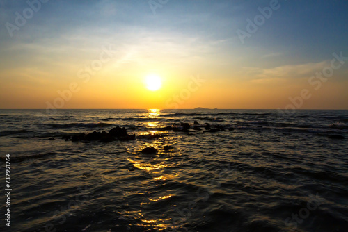 Sunrise on water in morning at beach