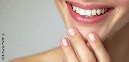 Close up of mouth of happy woman touching the corners of her mouth  Woman smiling while touching her flawless glowy skin with copy space for your advertisement  skincare.