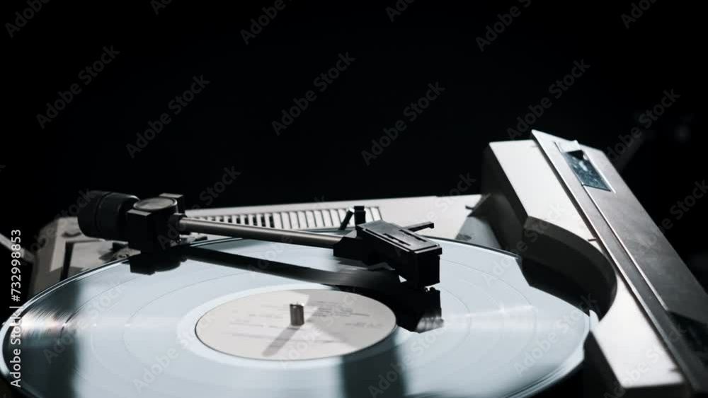 Vintage vinyl record rotates on the retro turntable, needle touches the