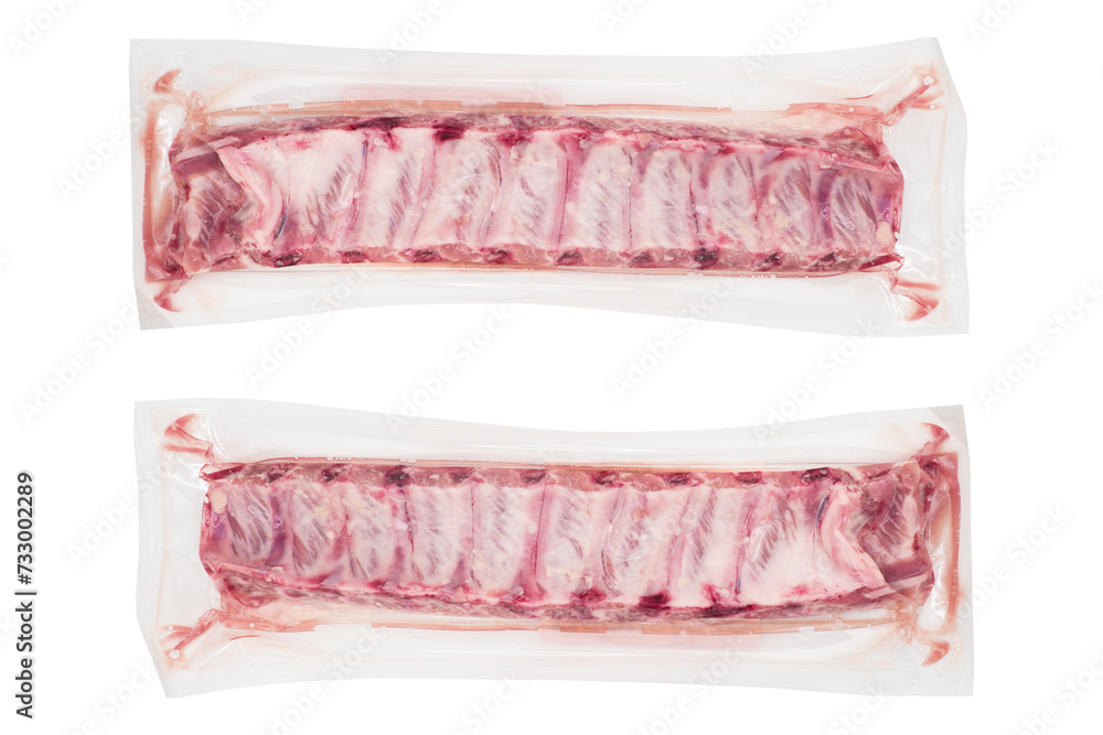 Pork meat ribs vaccuum packaged isolated on white background. Fresh pork meat ribs for barbecue. Strip of pork meat on ribs. BBQ pork ribs isolated over white