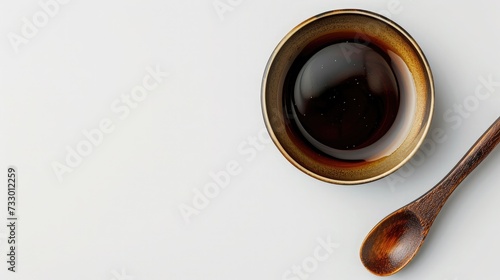A small dish with molasses on a white background.