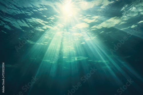 The sun casts its rays through the translucent depths of the ocean, creating an ethereal scene.