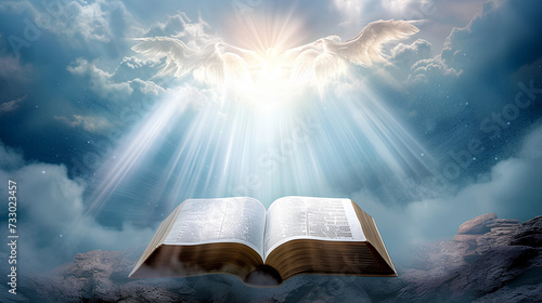 An open book with white pages and rays of light against the sky. photo