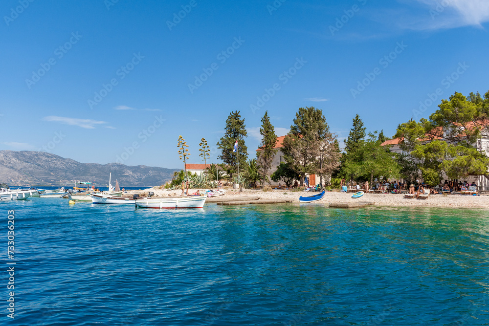 Boats moored by idyllic beach on Vrnik, a small island near Korcula, Croatia