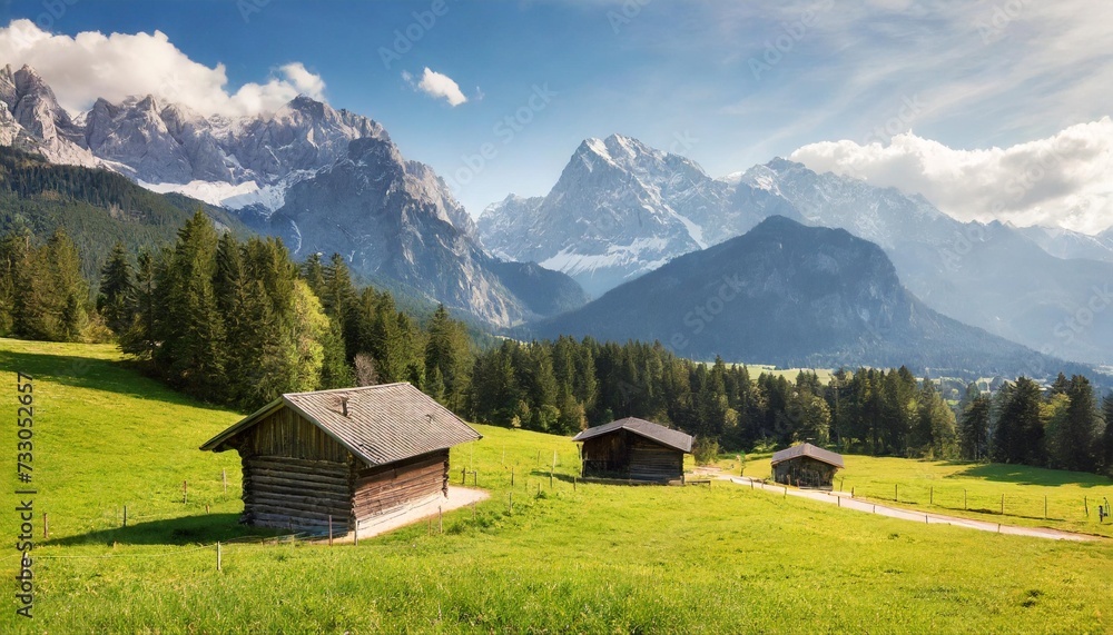 alpine green meadow and wooden barns zugspitze mount in the background garmisch partenkirchen bavaria germany alpine green meadow and wooden barns zugspitze mount in the background garmisch partenkirchen bavaria germany