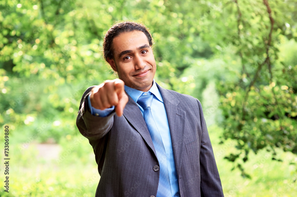 Handsome young business dark skin man pointing to you in park Handsome young business dark skin man pointing to you in park
