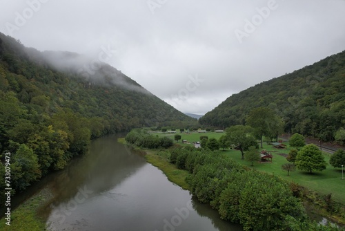 a river that is in front of a mountain and trees