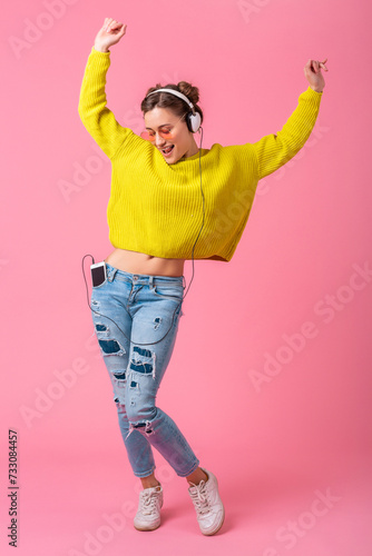 Canvas Print attractive woman in cheerful exited mood listening to music in headphones