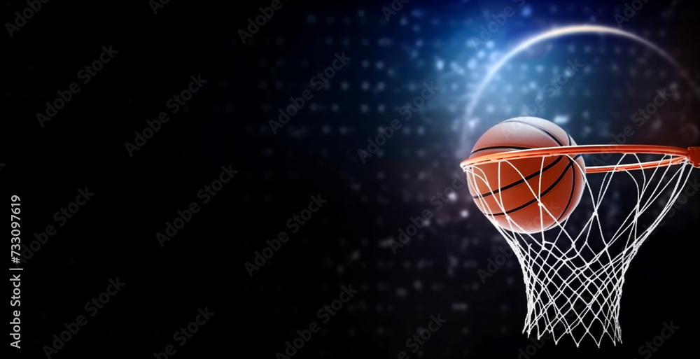 The ball went into the basket. banner basketball ball and hoop on a dark background. Blue lights. Copy space