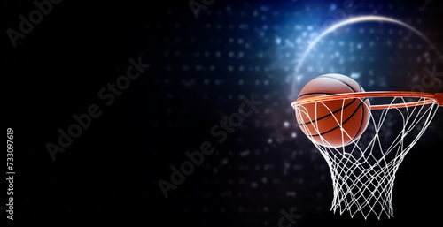 The ball went into the basket. banner basketball ball and hoop on a dark background. Blue lights. Copy space © Рика Тс