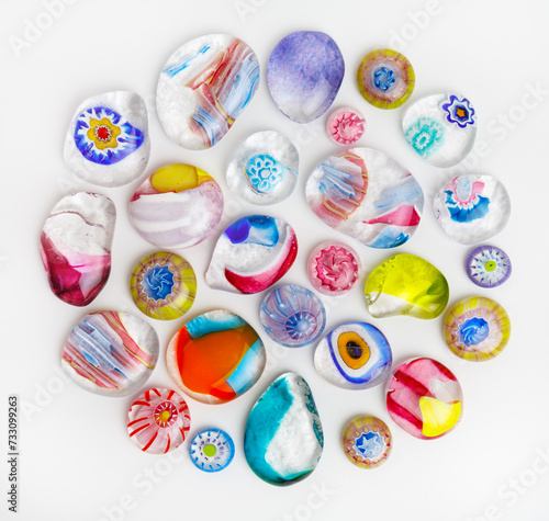 Collection of colorful glass beads of different sizes and shapes. Colored Venetian, Murano glass, millefiori. Flat lay, top view photo