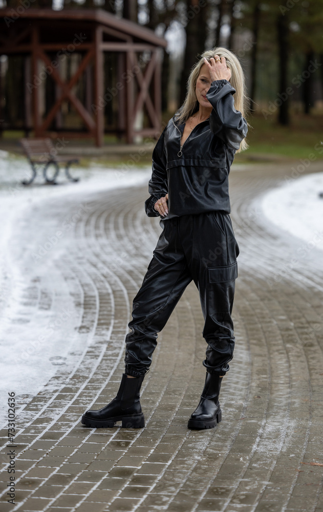 Portrait of a young beautiful woman in black coat on winter nature Portrait of a young beautiful woman in black coat on winter nature