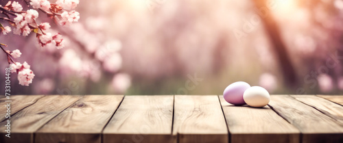 Wooden table with easter or spring theme blurred background , eggs and colorful flowers with copy space.