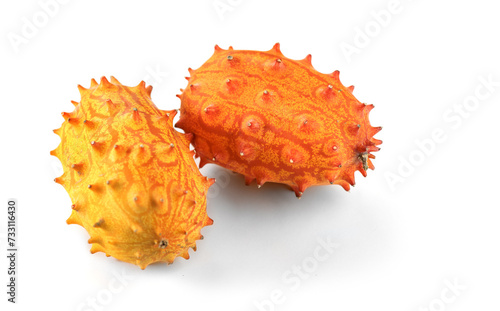 Kiwano fruit or Horned melon close up. Fresh and juicy African horned cucumber or jelly melon, hedged gourd liana whole exotic fruits closeup, isolated on white background. 