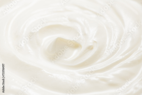 Sour cream or greek yogurt swirl texture, White cream background, close up. Dairy product. Delicious organic creamy yogurt. Milk cream 