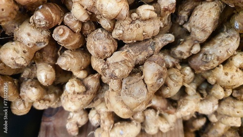 Close up pile of tasty fresh ginger sold at the market as a background.