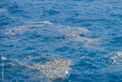 Ocean Pollution with Plastic Debris Floating on Water Surface