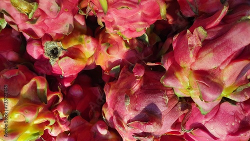 Close up pile of tasty fresh dragon fruit sold at the market as a background.