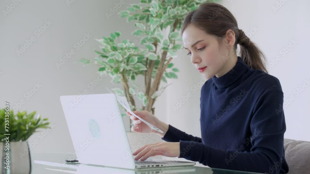 Asian woman in casual clothes uses computer at working space Asian woman in casual clothes uses computer at working space