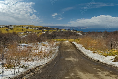 Russia. The Far East, the Kuril Islands. View of the spring nature from the dirt road along the island of Iturup.