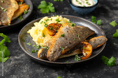 Pan fried sea bass fillets served with mashed potatoes and caramelised lemon photo