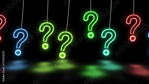 Glowing Neon Question Mark Moving On Black Background. Hanging Bright Neon Question Mark And Moving Animation. Glowing Question Mark Hanging Animation On Black Background. Randomly Color Changing Ques photo