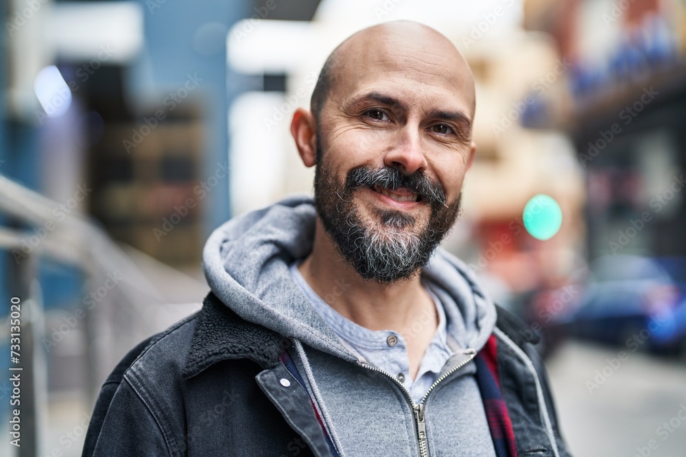 Young bald man smiling confident standing at street Young bald man smiling confident standing at street