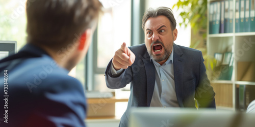 Angry office boss shouting, arguing and threatening his employee. Anger management concept.