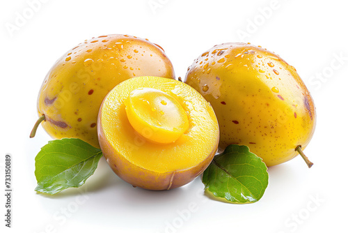 A close-up image of dew-kissed marula fruits. One fruit is halved, revealing its juicy yellow interior. The fruits are accompanied by fresh green leaves.