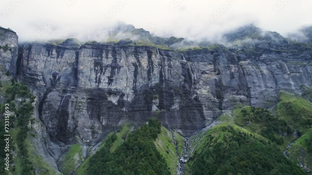 Giffre valley of mountain range with cascade and foggy in French Alps borderland at France Giffre valley of mountain range with cascade and foggy in French Alps borderland at France