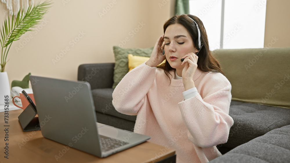 A young woman working from home appears stressed while on a call, evoking themes of remote work and modern lifestyle challenges. A young woman working from home appears stressed while on a call, evoking themes of remote work and modern lifestyle challenges.