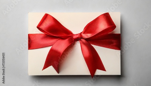 gift card with red ribbon bow on white background © Richard