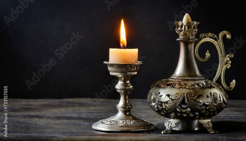 burning old candle vintage silver bronze candlestick black background