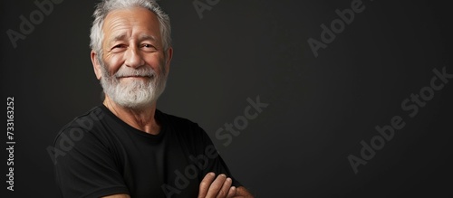Portrait a Senior man model in black t-shirt isolated dark background. Generated AI image