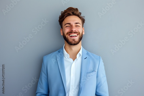 Portrait of Handsome smiling man in suit isolated on light background photo