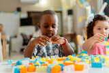 African little boy preschool playing with colored blocks in a kindergarten