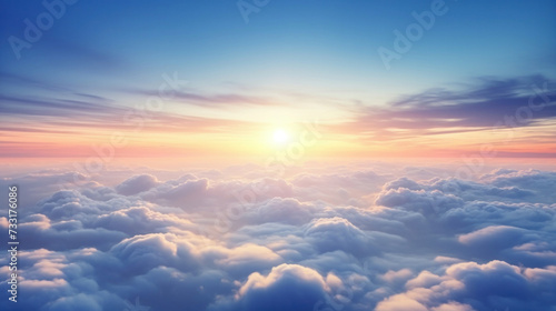 Aerial view of Beautiful sunrise sky above clouds or fog with dramatic light at dawn. © Wararat