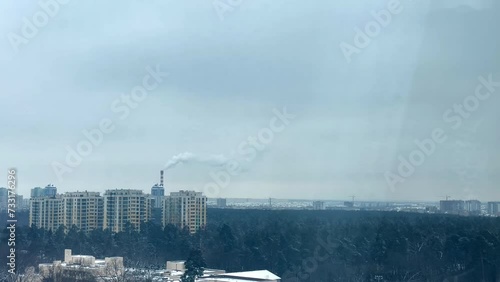 Dirty smoke comes out of an old factory chimney, polluting the environment. Toxic production company. Poisoned air. Epic pollution of nature. Toxic substances. Blue sky metallurgy.
