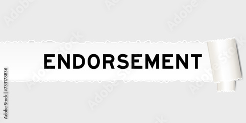 Ripped gray paper background that have word endorsement under torn part