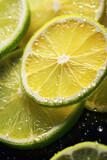 Close up of Lemon and lime slices drop in fizzy sparkling water, juice refreshment.
