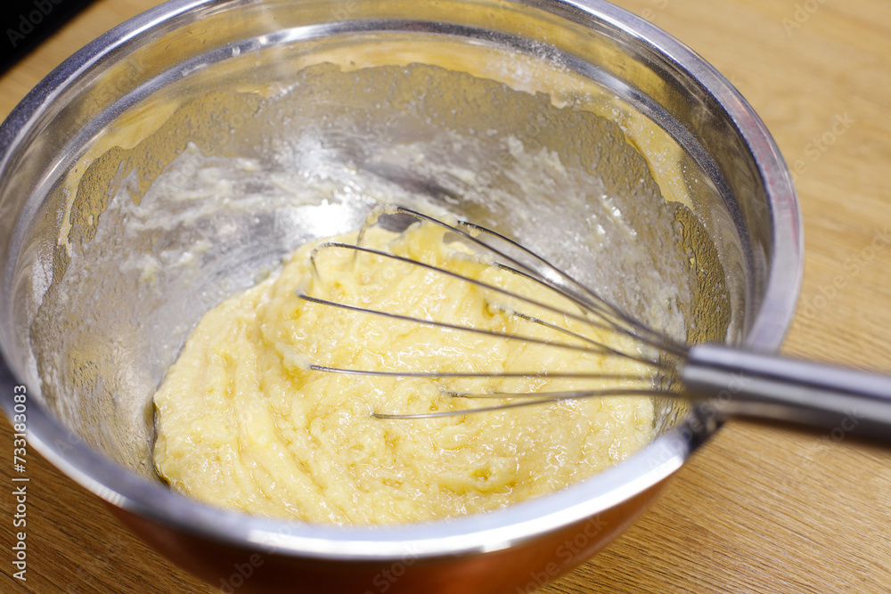dough with a whisk in a deep bowl