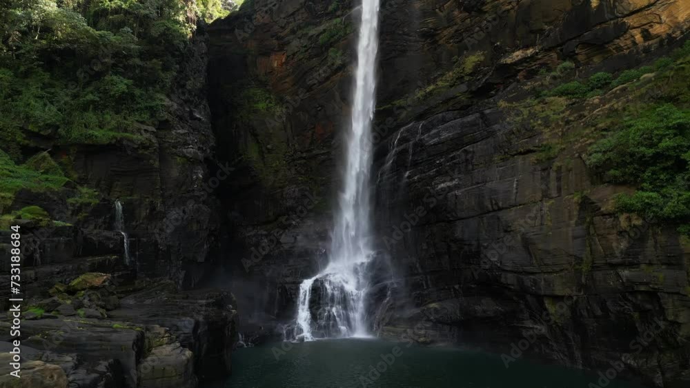 A majestic high tropical waterfall falling its stream on black rocks. Laxapana falls in Sri Lanka A majestic high tropical waterfall falling its stream on black rocks. Laxapana falls in Sri Lanka