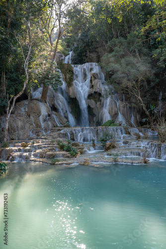 The Kuang Si Waterfall is located 30 km to the south of Luang Prabang in the Southeast Asian country of Laos.